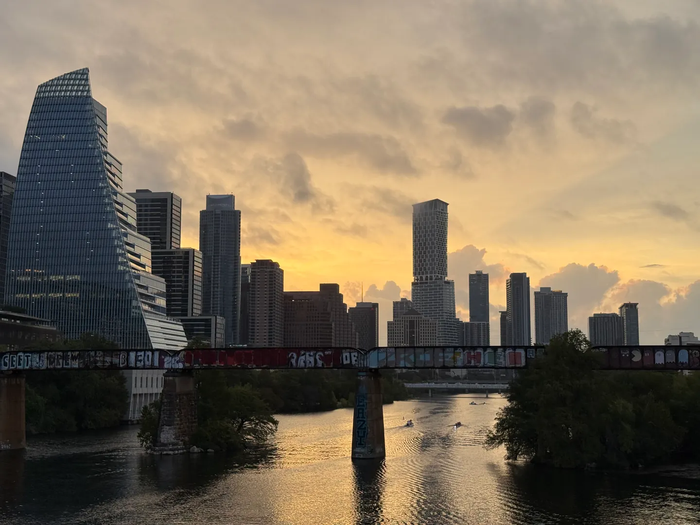 Downtown Austin skyline at sunrise, with a bridge over the river